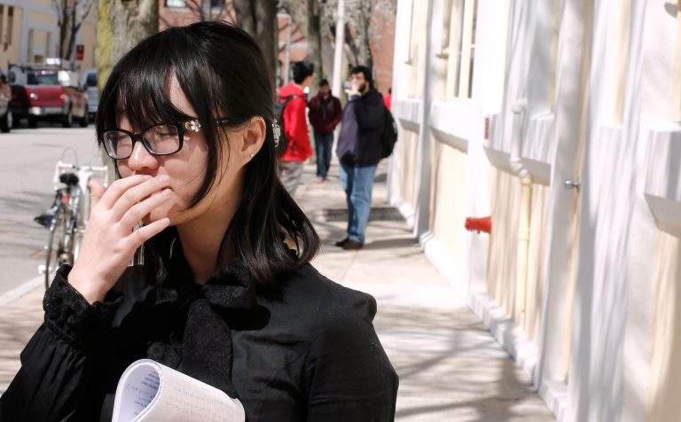 A Boston University student who knew Boston Marathon bombing victim Lu Lingzi pauses while talking about her friend outside the Boston University School of Mathematics and Statistics in Boston Wednesday, April 17, 2013. (AP Photo/Winslow Townson)