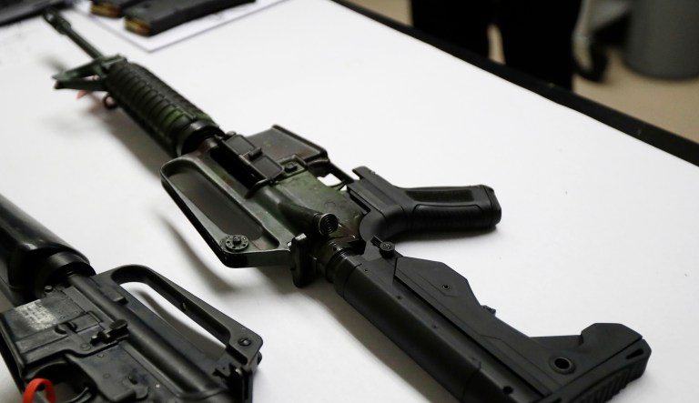 In this Jan. 11 photo, a semi-automatic rifle at right that has been fitted with a so-called 