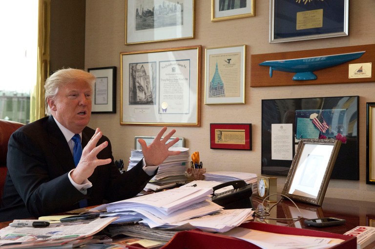 Donald Trump is seated behind his desk. A single camera feeds the shot to all networks that want to carry it. They all want to carry it. (AP Photo/Mary Altaffer)