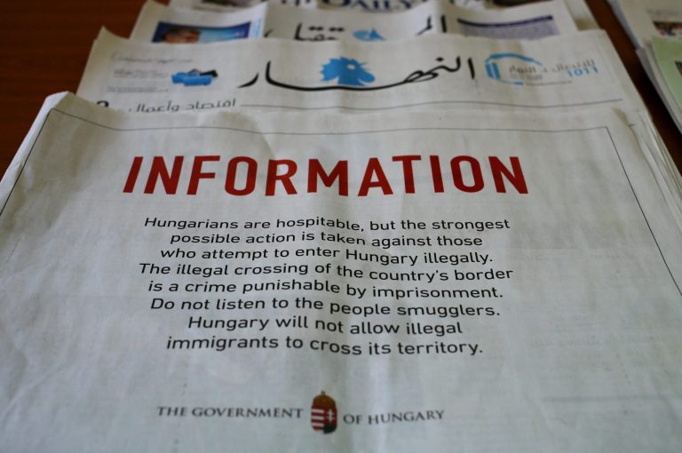 A full-page advertisement by the Hungarian government that was published in Lebanese newspapers, warning migrants not to enter the country illegally saying it is a crime punishable by imprisonment. (AP Photo/Hussein Malla)