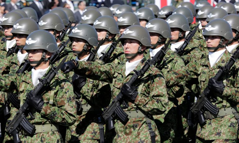 FILE - In this Oct. 27, 2013 file photo, members of Japan Self-Defense Forces march during the Self-Defense Forces Day at Asaka Base, north of Tokyo.  Japan's annual defense white paper approved by the Cabinet on Tuesday, Aug. 5, 2014, expresses strong concern about China's military build-up, citing its neighbor's increased airspace and maritime activities. But officials said separately that Japan's defense budget may be insufficient to achieve the goals set by Prime Minister Shinzo Abe to bolster the country's military.  (AP Photo/Shizuo Kambayashi, File)