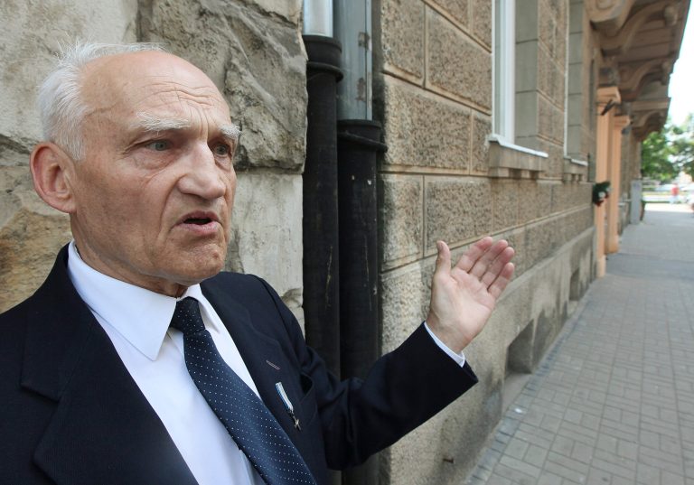 In this photo taken in Warsaw, Poland, Tuesday, July 8, 2014, Kazimierz Mikos, 84, shows buildings in Sienna street where in the 1944 Warsaw Rising he had his insurgent lodgings. As a 14-year-old boy Mikos was a guard and messenger in Warsawâs struggle against the occupying Nazi Germans. He will be among hundreds of fighters attending the ceremonies of the 70th anniversary of the ill-fated struggle that led to the destruction of some 30 percent of the cityâs substance and the loss of some 200,000 lives. (AP Photo/Czarek Sokolowski)