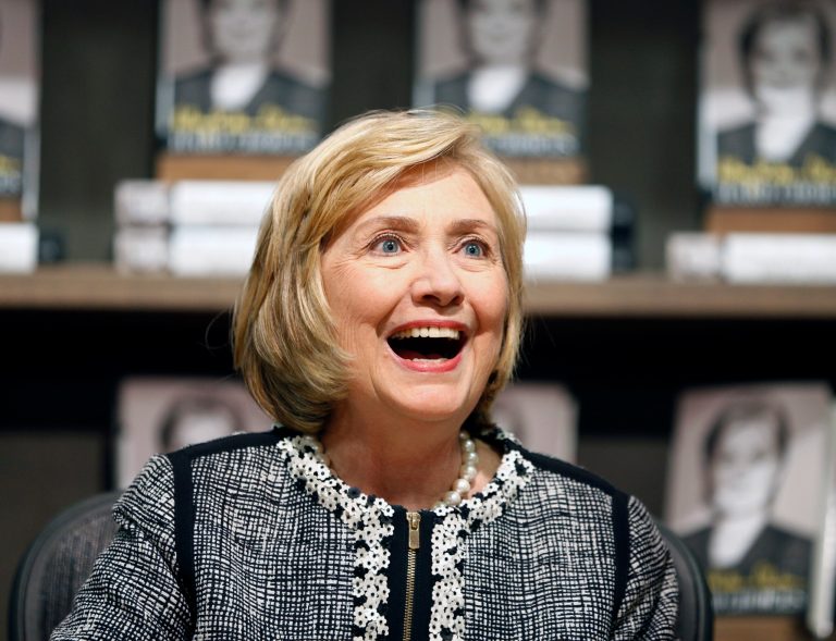 Hillary Clinton greets a customer during a book signing of her new book 