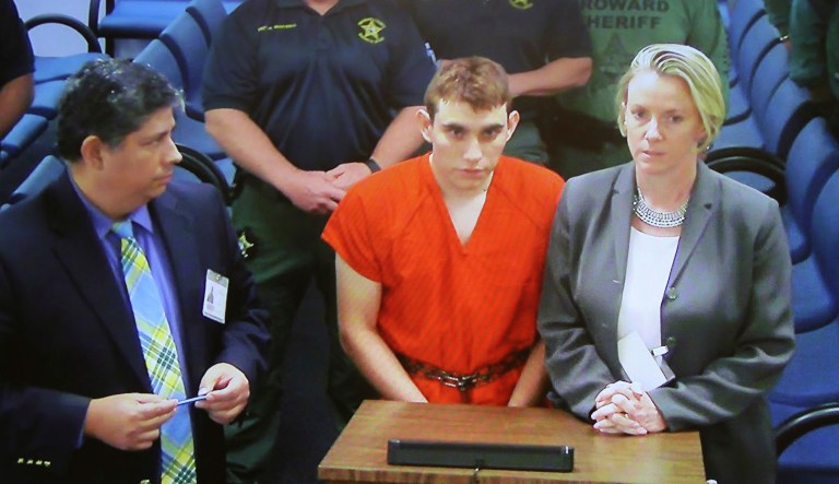 Nikolas Cruz, center, is accused of opening fire Wednesday at Marjory Stoneman Douglas High School in Parkland, Fla., killing more than a dozen people and injuring several. (Susan Stocker/South Florida Sun-Sentinel via AP, Pool)