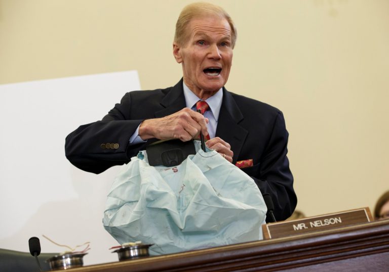 Senate Commerce Committee member Sen. Bill Nelson, D-Fla. displays the parts and function of a defective airbag made by Takata of Japan that has been linked to multiple deaths and injuries in cars driven in the US., Thursday, Nov. 20, 2014, during the committee's hearing on Capitol Hill in Washington. (AP Photo/J. Scott Applewhite)