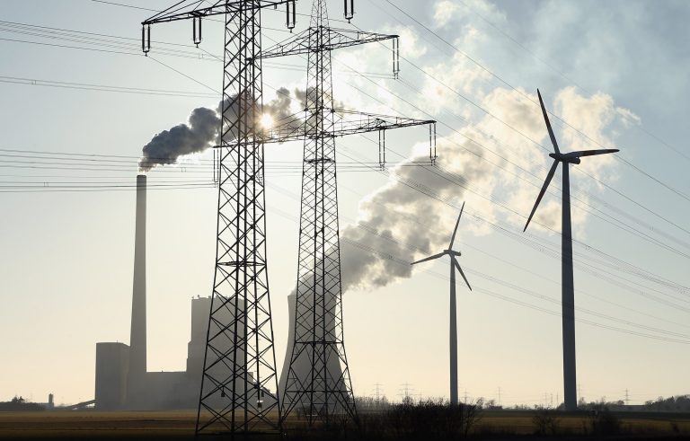 Wind turbines and electricity pylons flank the Mehrum coal-fired power plant (Kohlekraftwerk Mehrum) on March 4, 2013 near Hohenhameln, Germany. (Photo by Sean Gallup/Getty Images)