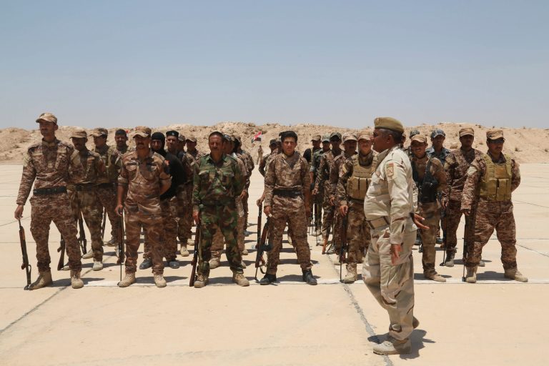Sunni tribal volunteers stand in formation during their graduation ceremony in Habaniyah, 80 kilometers (50 miles) west of Baghdad, Iraq. Wednesday, June 17, 2015. (AP Photo/ Khalid Mohammed)