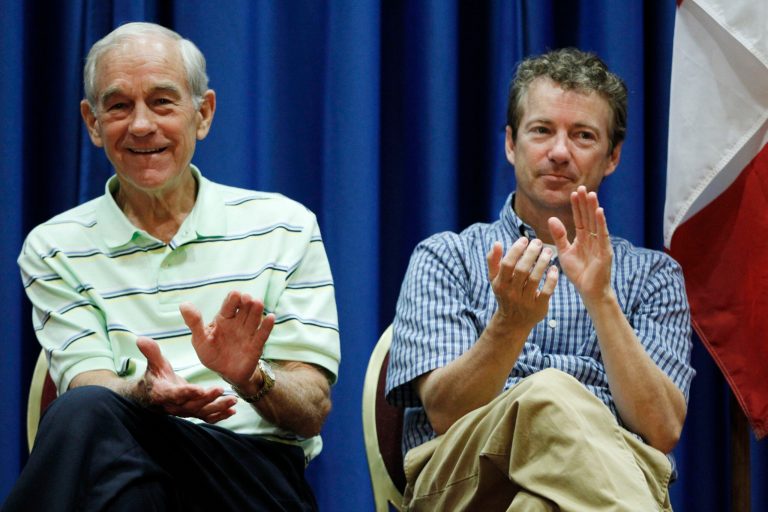 Republican presidential candidate Rep. Ron Paul, R-Texas, left, and his son, Sen. Rand Paul, R-Ky., applaud on stage at a campaign event at a hotel in Des Moines, Iowa, Wednesday, Aug. 10, 2011. (AP Photo/Charles Dharapak)