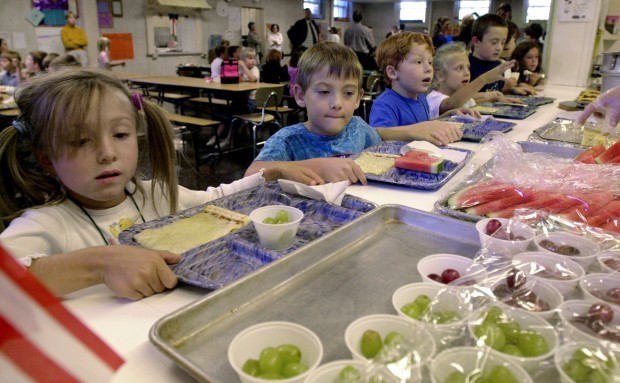 A new investigation of the federal school lunch program finds evidence of substantial waste. (AP Photo)