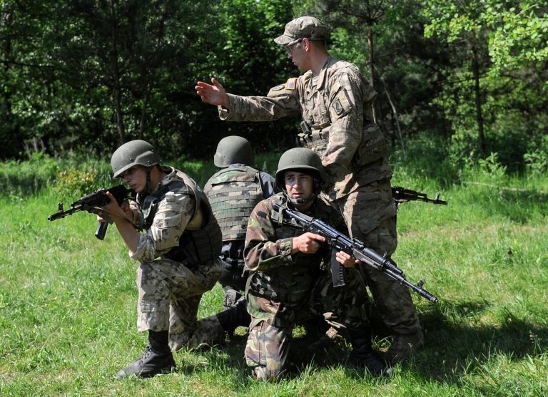 A U.S. soldier, right, instructs Ukrainian soldiers during joint training exercises on the military base in the Lviv region, western Ukraine, Wednesday, June 3, 2015. (AP Photo)Â 