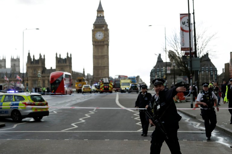 Police secure the area on the south side of Westminster Bridge close to the Houses of Parliament in London, Wednesday, March 22, 2017. The leader of Britain's House of Commons says a man has been shot by police at Parliament. David Liddington also said there were 