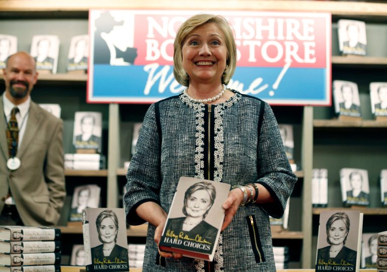 Hillary Clinton holds her new book 