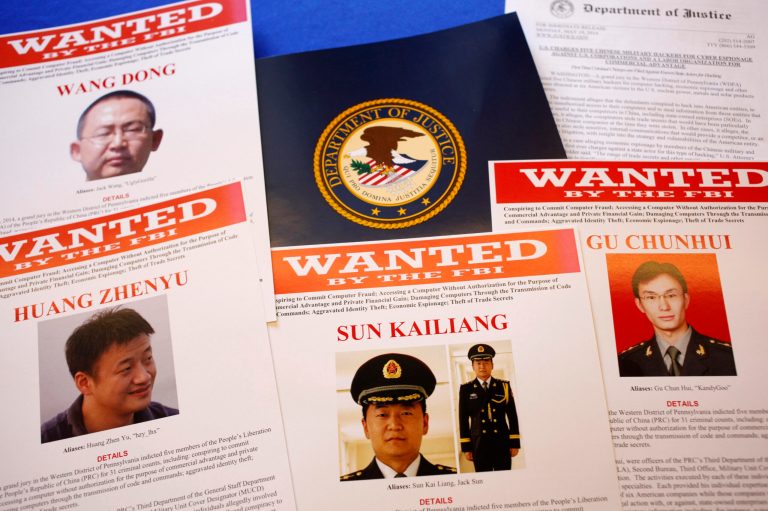 Press materials are displayed on a table of the Justice Department in Washington, Monday, May 19, 2014, before Attorney General Eric Holder was to speak at a news conference. Holder was announcing that a U.S. grand jury has charged five Chinese hackers with economic espionage and trade secret theft, the first-of-its-kind criminal charges against Chinese military officials in an international cyber-espionage case. (AP Photo/Charles Dharapak)