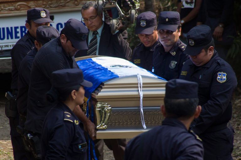 In this April 16, 2014 photo, police officers carry the casket containing the body of police investigator Elmer Antonio Bautista during a burial ceremony in Izalco, El Salvador. According to the police, Bautista was murdered by members of the Mara 18 gang while on duty. (AP Photo/Salvador Melendez)