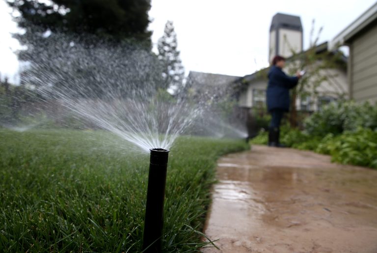 WALNUT CREEK, CA - APRIL 07: East Bay Municipal Utility District (EBMUD) water conservation technician Rachel Garza inspects a sprinkler system as she performs a water conservation audit of a home on April 7, 2015 in Walnut Creek, California. (Photo by Justin Sullivan/Getty Images)