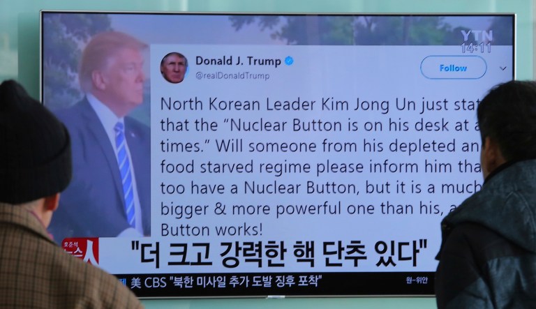 People watch a TV news program showing the Twitter post of President Trump while reporting North Korea's nuclear issue. Media criticized Trump's tweet as being 