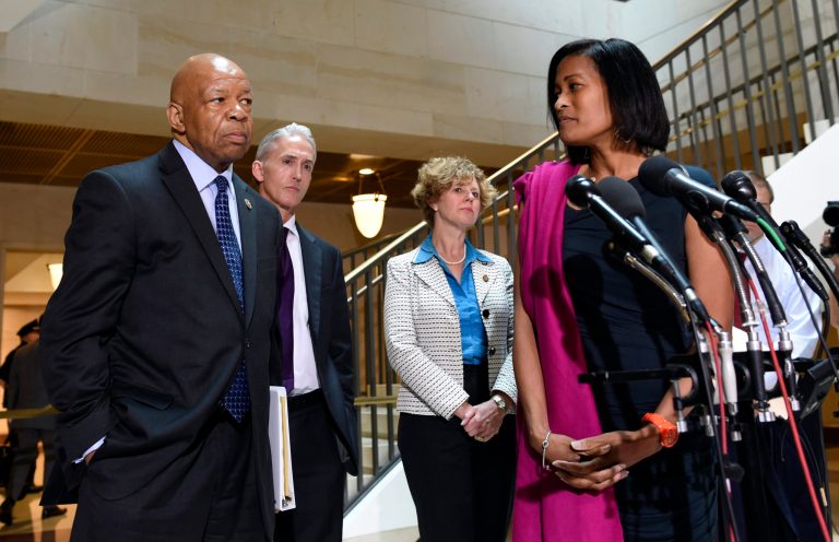 Former Hillary Rodham Clinton aide Cheryl Mills, right, turns to look at House Select Committee on Benghazi Chairman Trey Gowdy, R-S.C., second from left, and ranking member Rep. Elijah Cummings, D-Md., left, as she speaks to reporters on Capitol Hill in Washington, Thursday, Sept. 3, 2015. (AP Photo/Susan Walsh)