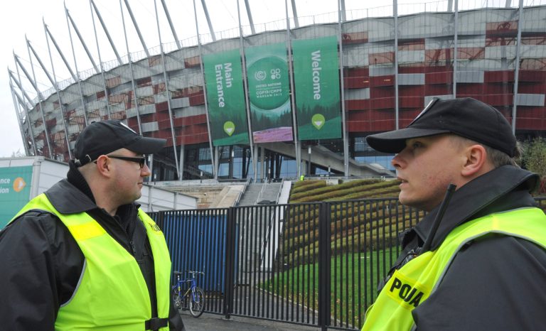 Police officers guard the National Stadium, the venue of the U.N. Climate Change Conference, in Warsaw, Poland, Sunday, Nov. 10, 2013. Climate envoys from rich countries, emerging economies and low-lying nations at risk of being swamped by rising seas will meet in Poland Monday for the next two weeks to lay the groundwork for a new global warming pact. (AP Photo/Alik Keplicz)