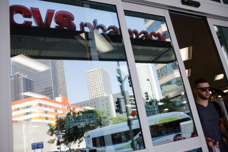 A customer exits a CVS pharmacy in downtown Los Angeles in October 2017. The drug-store chain is planning to use some of the $1.2 billion cash from a GOP-led tax overhaul to repay debt amid its $69 billion purchase of insurer Aetna. Photographer: Christopher Lee/Bloomberg