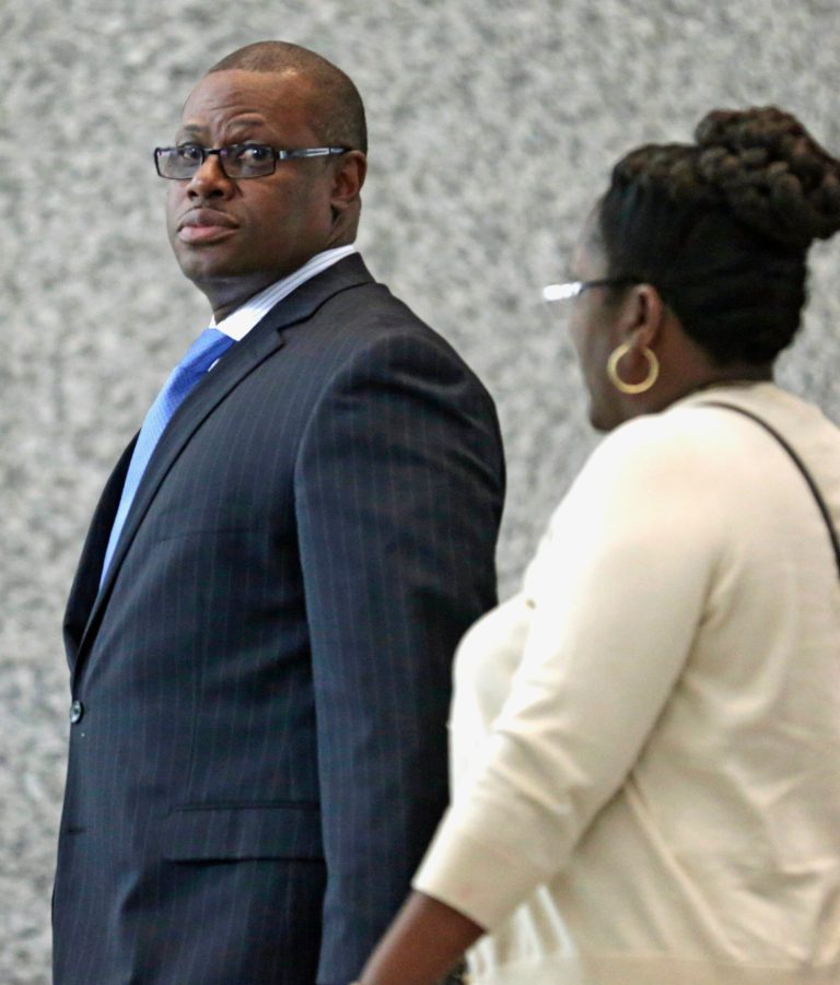 In this May 28, 2014 photo, Illinois state Rep. Derrick Smith enters federal court for the beginning of jury selection in his corruption trial in Chicago. During closing arguments Monday, June 9, 2014, prosecutors said that Smith placed his own welfare above his constituents by taking a $7,000 bribe from a day care operator seeking a state grant. An attorney for Smith, however, told jurors a campaign worker-turned-informant hoodwinked the Chicago Democrat to justify cooperation payments from his FBI handlers. (AP Photo/M. Spencer Green)