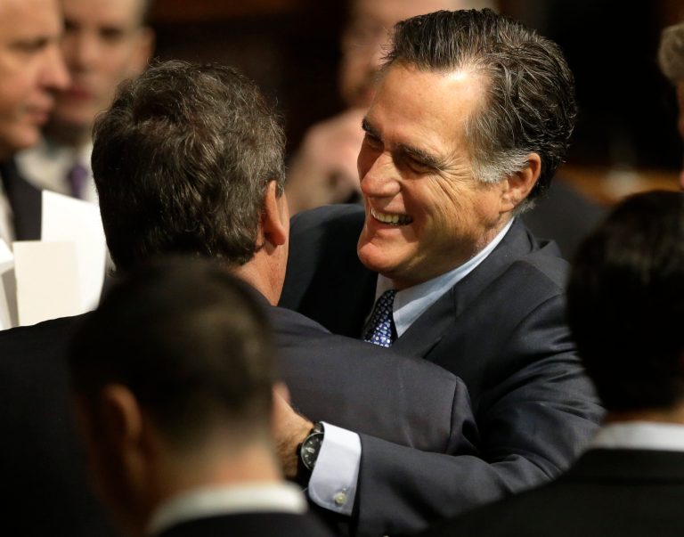 Former Massachusetts Gov. Mitt Romney, right, hugs N.J. Gov. Chris Christie, left, on the floor of the House Chamber at the Statehouse, in Boston, Thursday, Jan. 8, 2015, before inaugural ceremonies for Charlie Baker. 
Baker was sworn in as governor during a ceremony in the House Chamber before members of the state Supreme Judicial Court, House and Senate lawmakers, and other top elected officials. (AP Photo/Steven Senne)