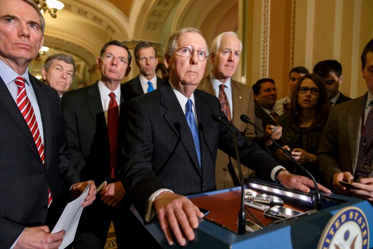 Senate Minority Leader Mitch McConnell of Ky., center, accompanied by fellow Republican senators, take questions on Capitol Hill in Washington, March 11, 2014, following a GOP caucus lunch. (AP Photo/J. Scott Applewhite)