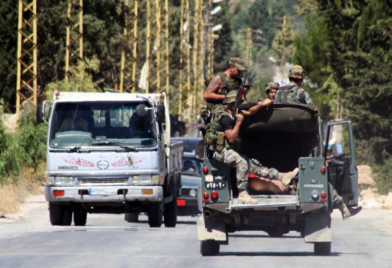 Lebanese soldiers ride in the back of an army vehicle with detained suspected militants in the Lebanese town of Arsal, a primarily Sunni Muslim town near the Syrian border in eastern Lebanon, Sunday, Aug 3, 2014. At least 10 Lebanese Army soldiers were killed and over a dozen were captured in Arsal, while tens of militants have been killed, during clashes between the Army and Syrian armed groups, according to security sources. (AP Photo)
