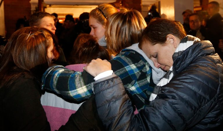   Girls embraces outside St. Rose of Lima Roman Catholic Church, which was filled to capacity, during a healing service held in for victims of an elementary school shooting in Newtown, Conn., Friday, Dec. 14, 2012. A gunman opened fire at Sandy Hook Elementary School in Newtown, killing 26 people, including 20 children. (AP Photo/Charles Krupa)  