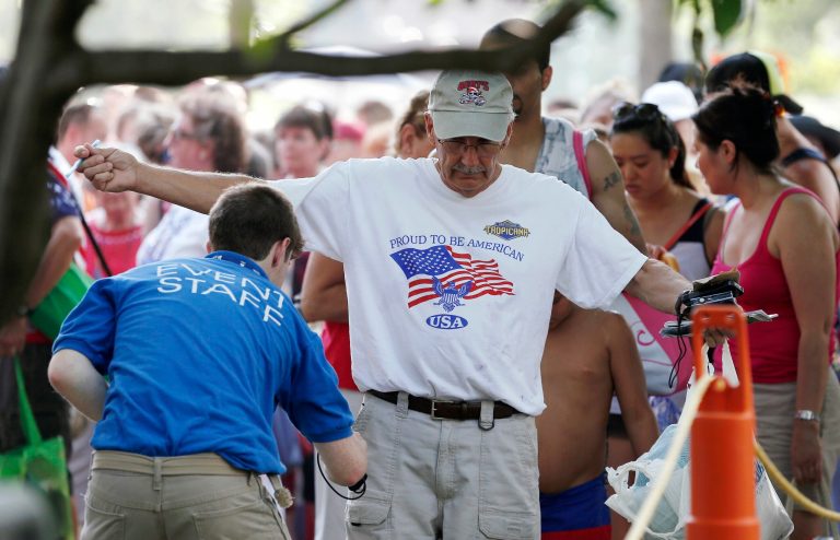 People pass through a security checkpoint before a concert at the Hatch Shell on the Esplanade in Boston, Thursday, July 3, 2014. (AP Photo/Michael Dwyer)