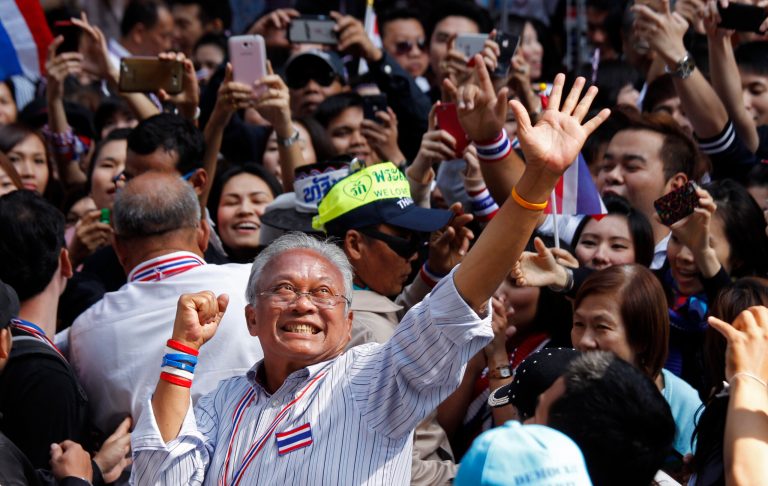 Anti-government protest leader Suthep Thaugsuban waves to supporters during a march through the streets of central Bangkok, Thailand, Tuesday, Jan. 21, 2014.  Thailand has declared a state of emergency in Bangkok and its surrounding areas to cope with anti-government protests that have stirred up violent attacks. (AP Photo/Wally Santana)