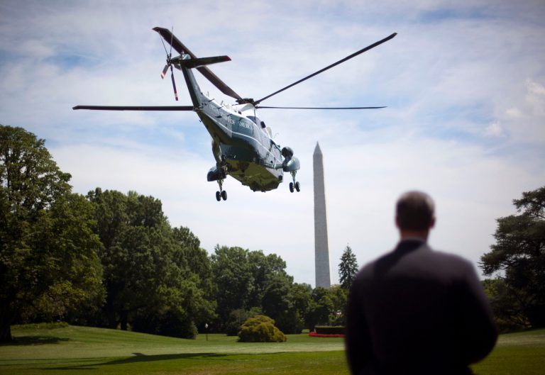 A Secret Service agent closes the gate to the flight line at Andrews Air Force Base, Md., Tuesday, July 14, 2015, in preparation of President Barack Obama's arrival. (AP Photo/Cliff Owen)