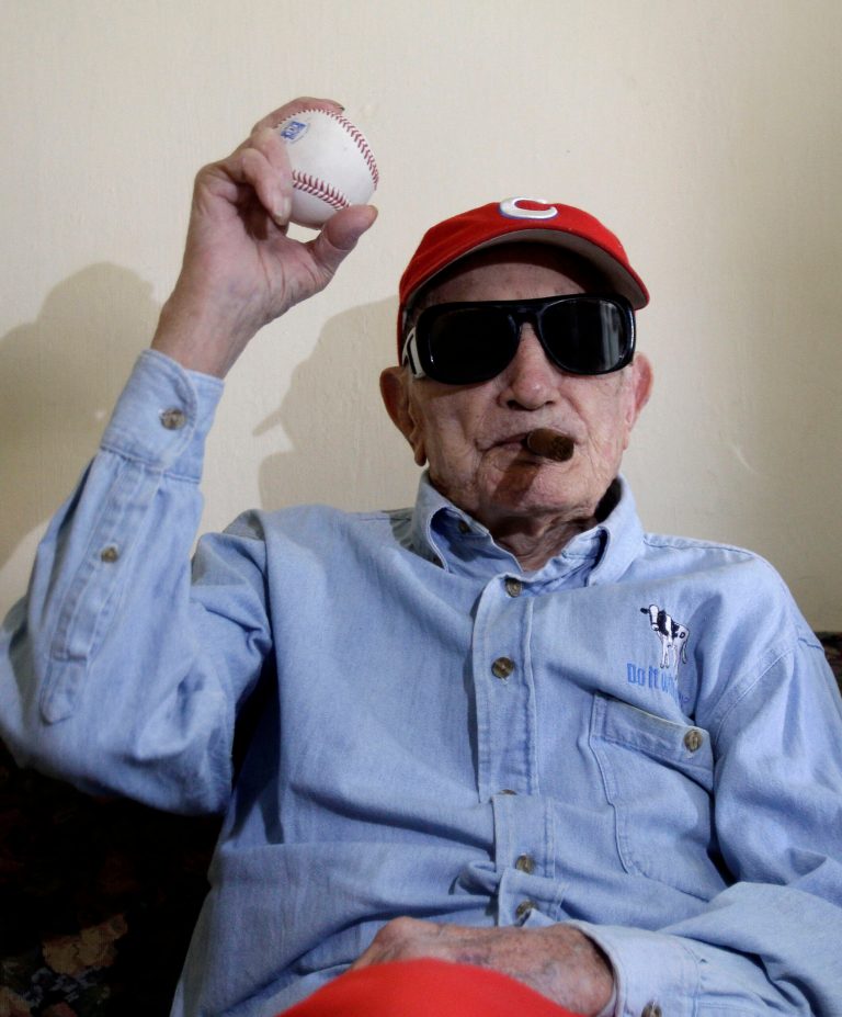 FILE - In this April 25, 2012 file photo, Conrado Marrero holds up a baseball as he poses for pictures during an interview in Havana, Cuba. Family members say Conrado Marrero, the oldest living former Major League Baseball player,  has died in Havana. He was 102, just two days short of his 103rd birthday. Grandson Rogelio Marrero confirmed the death Wednesday afternoon, April 23, 2014.  (AP Photo/Franklin Reyes, File)