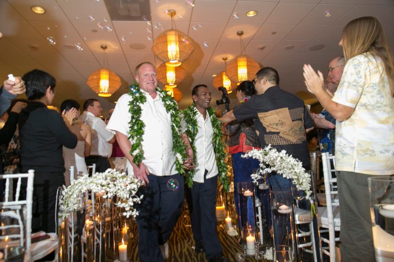 Shaun Campbell, left, and partner Tony Singh are congratulated by guests after their wedding at the Sheraton Waikiki on Monday in Honolulu. (AP/Marco Garcia)