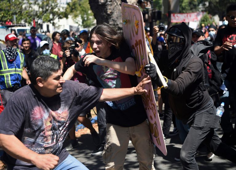 Demonstrators clash during a free speech rally Sunday, Aug. 27, 2017, in Berkeley, Calif. Several thousand people converged in Berkeley Sunday for a 