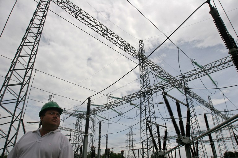 A supervisor walks past power lines at the Electrical Transmission Company, ENTRESA, in Managua, Nicaragua, Sept, 13, 2005. (AP Photo/Esteban Felix)