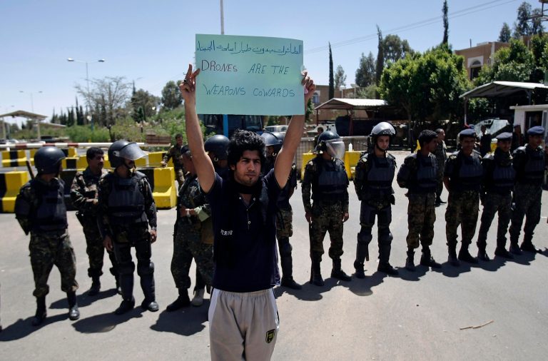 FILE - In this Monday, April 29, 2013 file photo, a Yemeni man holds a banner during a protest to denounce American drone attacks in Yemen, in front of the U.S. embassy in Sanaa, Yemen. A public backlash is starting to grow in Yemen over civilians killed by American drones as the U.S. dramatically steps up its strikes against al-Qaida's branch here the past year. Relatives of those killed say the missile blasts hitting their towns only turn Yemenis against the U.S. campaign to crush militants. (AP Photo/Hani Mohammed, File)