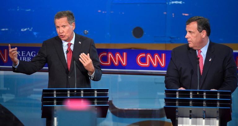 A new ad from a super PAC backing Ohio Gov. John Kasich, left, targets New Jersey Gov. Chris Christie. (AP Photo/Mark J. Terrill)