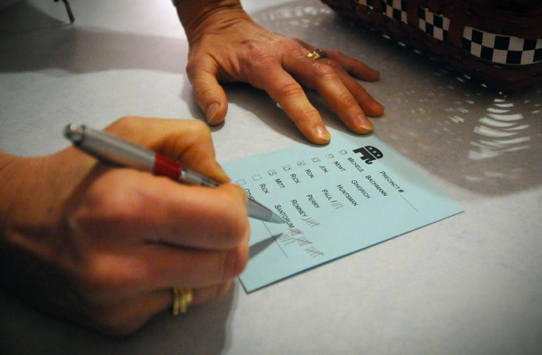 Barb Hansen tallies votes during a caucus of precinct 42 near Smithland, Iowa Tuesday, Jan. 3, 2012. (AP Photo/Dave Weaver)