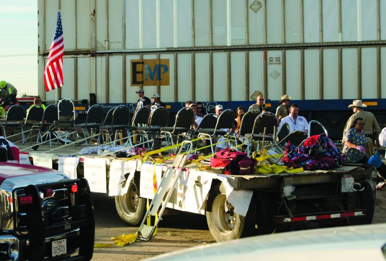 FILE - In this Nov. 15, 2012 file photo authorities respond to an accident involving a trailer carrying wounded veterans that was struck by a train during a parade in Midland, Texas. 50-year-old Army veteran who served in Iraq and Afghanistan was driving the parade float that investigators say edged across a railroad crossing in Texas despite warning signals of a fast approaching train, the man's attorney said Tuesday, Nov. 20, 2012. Four veterans and sixteen people were injured in the resulting collision. (AP Photo/Reporter-Telegram, Tim Fischer, File)