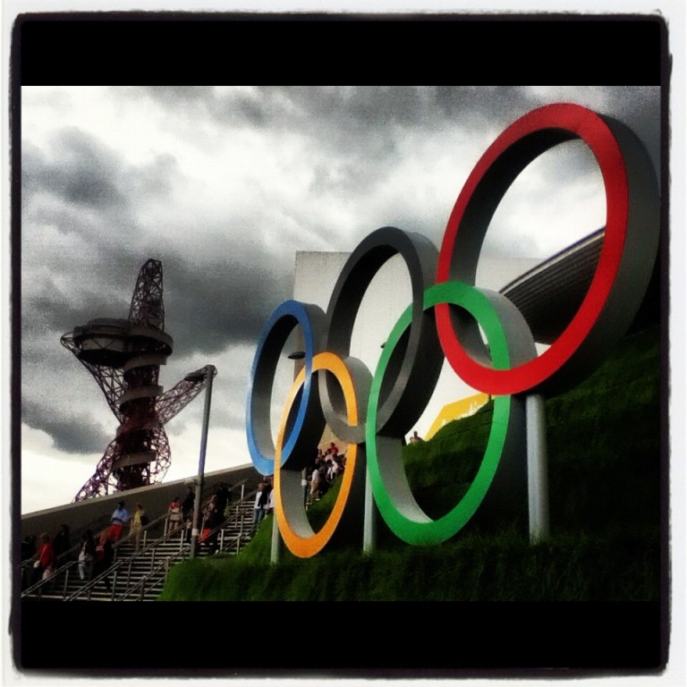 Olympic rings and the ArcelorMittal Orbit at Olympic Park are shown outside of the Aquatic Centre during the London 2012 Olympic Games. (Getty Images)