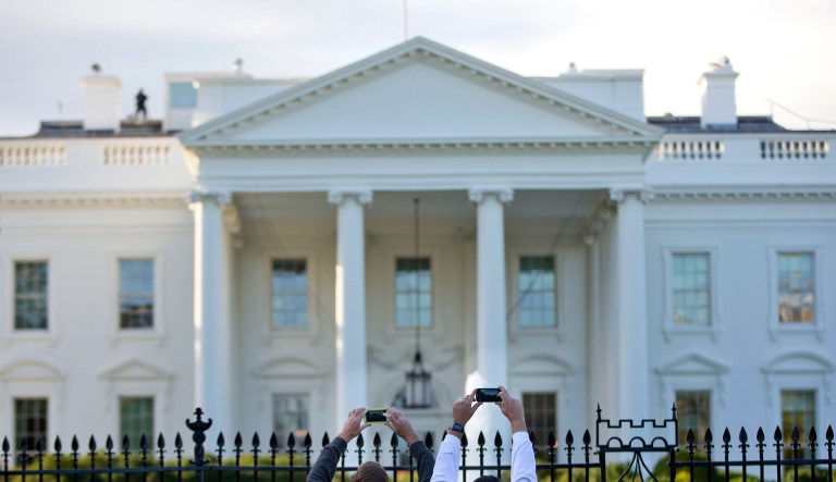 Visitors take photos of the White House on the sidewalk in front of the White House in Washington. (AP Photo/Pablo Martinez Monsivais)