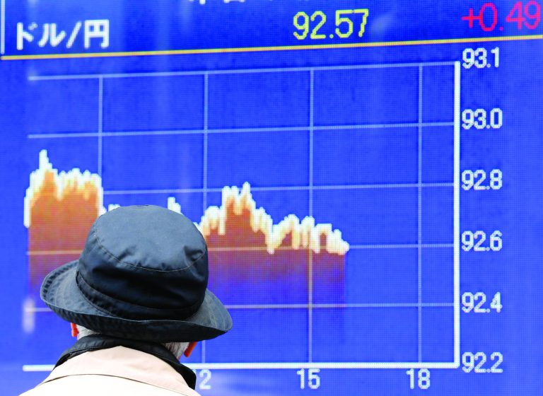 A man checks the U.S. dollar exchange rate to the yen at a securities firm in Tokyo Monday, Feb. 4, 2013. Asian stock markets were mostly higher Monday as investors continued to feel confident about stocks following last week's U.S. jobs report and Wall Street's rally. (AP Photo/Koji Sasahara)