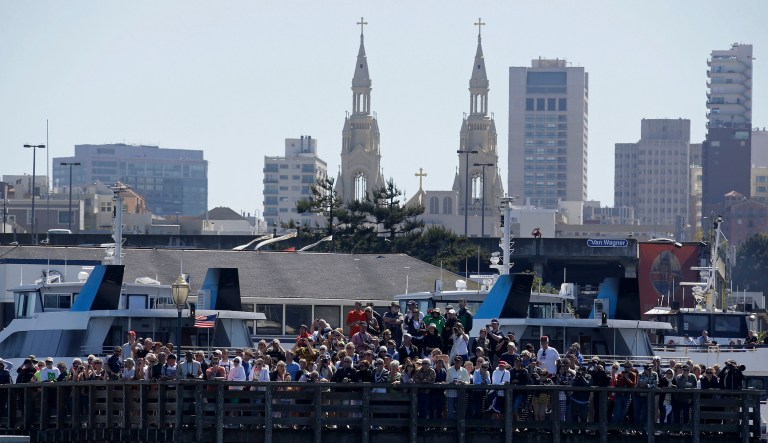 In this Sept. 18, 2013, file photo, spectators at Pier 39 watch Emirates Team New Zealand and Oracle Team USA during the 11th race of the America's Cup sailing event in San Francisco. The FBI said Friday, Dec. 22, 2017, that it found a martyrdom letter and several guns in the home of a former Marine who may have been planning a Christmas Day attack on a popular San Francisco tourist destination. (AP Photo/Eric Risberg, File)