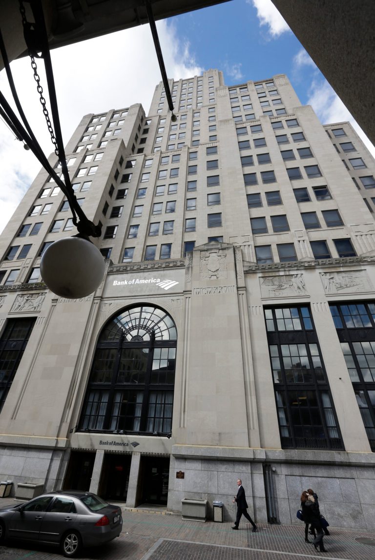 In this Wednesday, March 27, 2013 photo, the 26-story Bank of America Building stands near a street lamp, left, and flag pole on a neighboring building in downtown Providence, R.I. The Art Deco-style skyscraper, tallest in the state, is losing its last tenant when the bank's lease expires in April. The building is known to some as the 