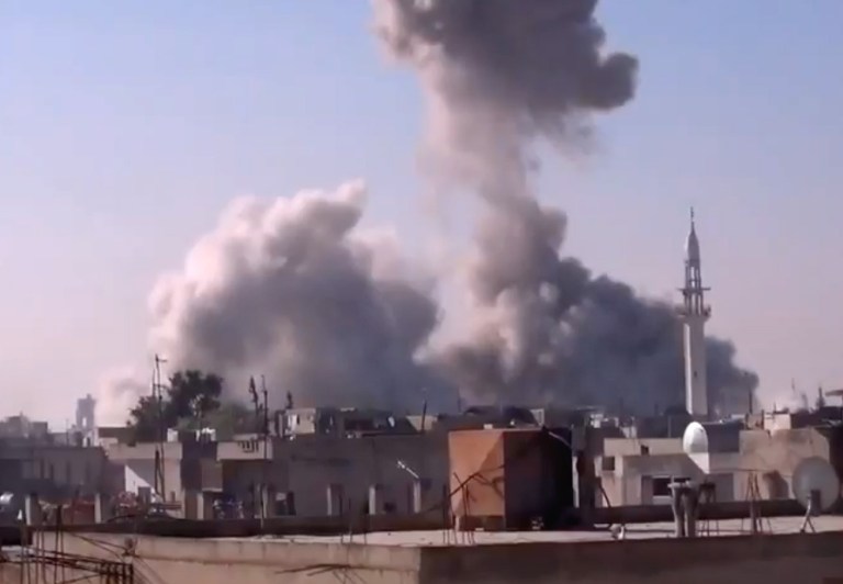   In this image taken from video obtained from the Shaam News Network, which has been authenticated based on its contents and other AP reporting, smoke rises from buildings from heavy shelling in Homs, Syria, on Thursday, Dec. 27, 2012. (AP Photo/Shaam News Network via AP video)  