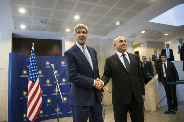 Kerry, left, shakes hand with Turkey's foreign minister Mevlut Cavusoglu on Friday. (AP Photo/Brendan Smialowski, Pool)