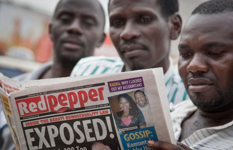 A Ugandan reads a copy of the 