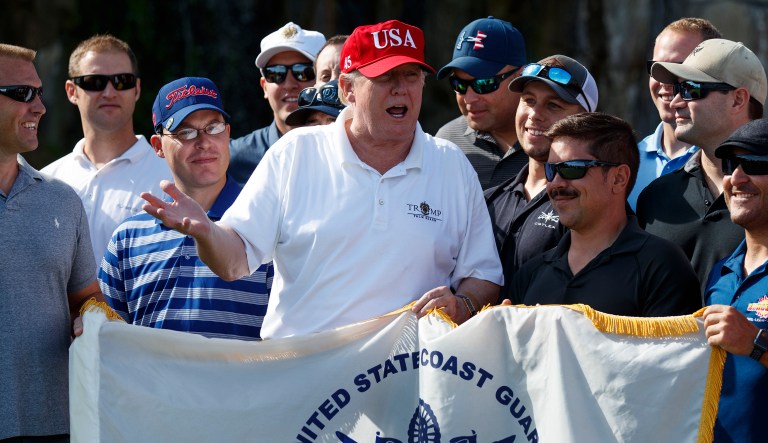 President Trump met with members of the U.S. Coast Guard, who he invited to play golf, at Trump International Golf Club on Friday in West Palm Beach, Fla. (AP Photo/Evan Vucci)