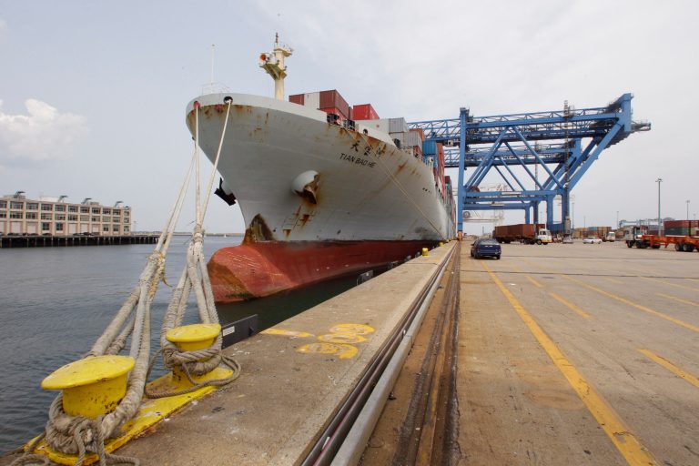   In this Friday, July 13, 2012, photo, a container is loaded onto a ship from China at Massport's Conley Terminal in the port of Boston. The U.S. current account trade deficit narrowed in the July-September quarter to the smallest level since late 2010, but the improvement may not last. (AP Photo/Stephan Savoia)  