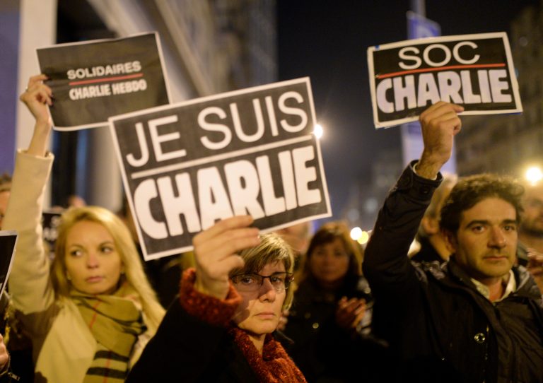 People attend a demonstration in solidarity with those killed in an attack at the Paris offices of weekly newspaper Charlie Hebdo, at the French Consulate in Barcelona, Spain, Wednesday, Jan 7, 2015. (AP Photo/Manu Fernandez)